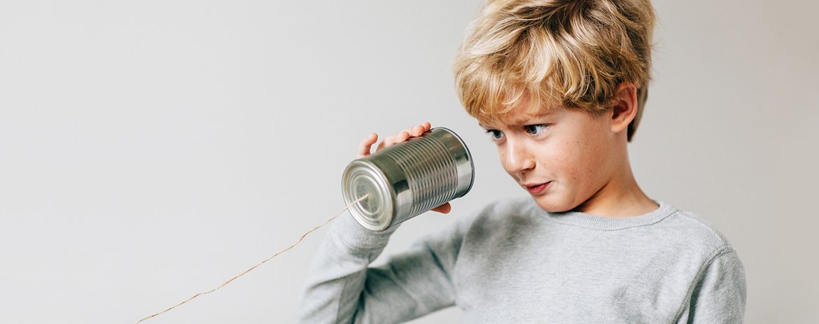 Boy looking into makeshift phone
